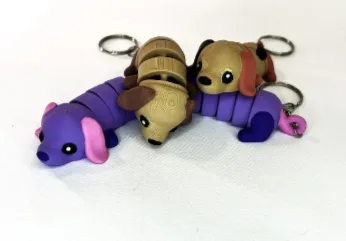 Llaveros de perritos articulados en violeta y marrón